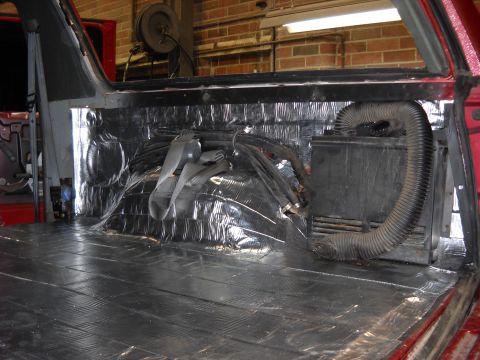 1993 Ford C-150 (Centurion Conversions) - The interior of a vehicle is being modified with sound dampening materials and exposed ductwork.