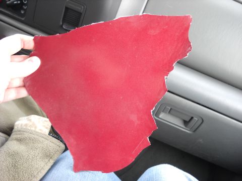 1993 Ford C-150 (Centurion Conversions) - A hand holds a torn piece of red material against the interior of a vehicle.
