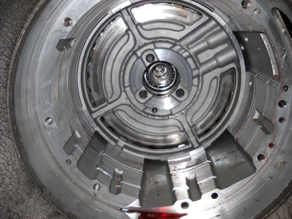 Close-up of an automatic transmission torque converter pump with visible internal vanes and a bearing