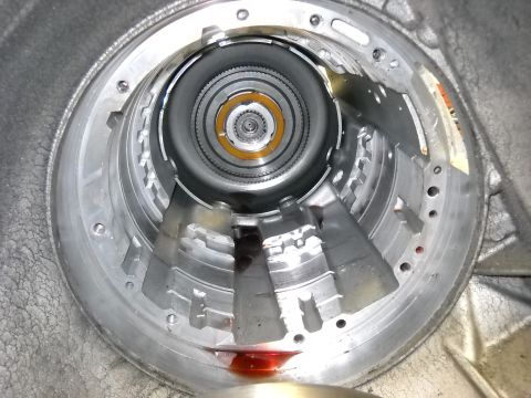 1993 Ford C-150 (Centurion Conversions) - Close-up view of the internal workings of an automatic transmission, with red fluid visible.