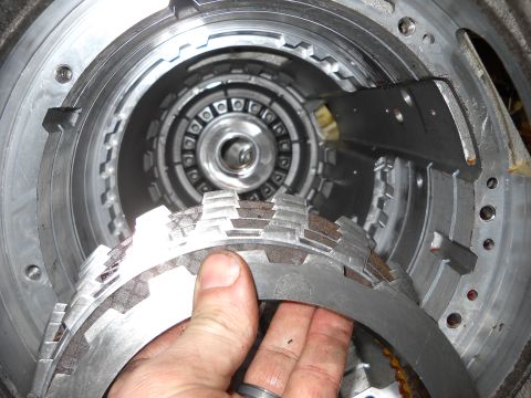 1993 Ford C-150 (Centurion Conversions) - Close-up of a transmission clutch pack, revealing worn friction plates during a rebuild.