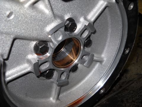 1993 Ford C-150 (Centurion Conversions) - Transmission torque converter housing with a bronze bushing and six bolts visible.