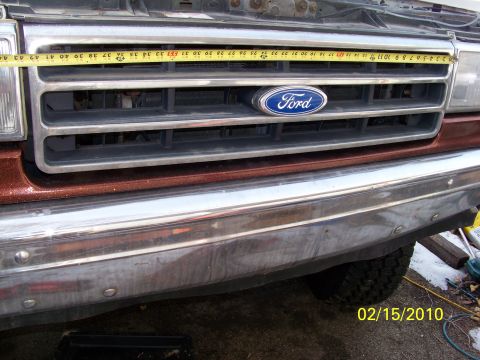 1989 Ford Bronco - A tape measure is placed across the grille of a Ford truck, showing the front end detail.