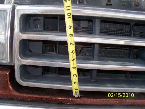 1989 Ford Bronco - A tape measure is placed across the front grille of a vehicle, with a date stamp of 02/15/2010 visible.