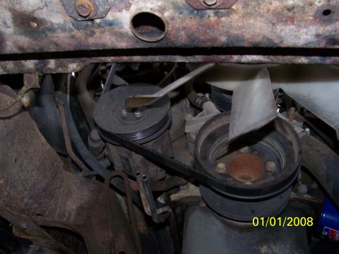 1989 Ford Bronco - This image shows the engine compartment with a focus on the belt-driven pulleys and fan assembly.