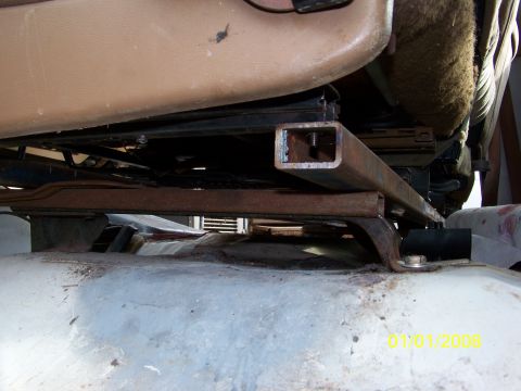 1989 Ford Bronco - Close-up view of a custom seat mounting bracket installed in a vehicle's interior.