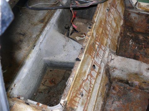 1976 Chevrolet Corvette - Interior floor pan shows significant rust and corrosion.
