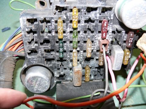 1976 Chevrolet Corvette - A close-up view of a vehicle's fuse box, showing multiple fuses and electrical wiring.