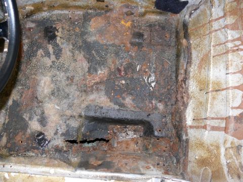 1976 Chevrolet Corvette - This heavily rusted floor pan shows significant deterioration and holes.