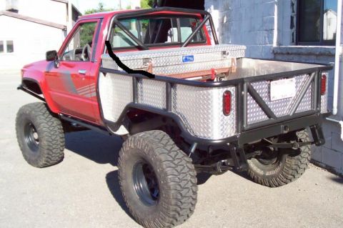 1989 Ford Bronco - This modified pickup truck features a custom flatbed, roll cage, and off-road tires, suggesting a focus on utility and off-road capability.