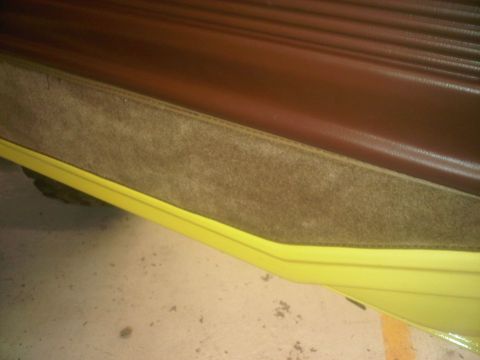 1978 Ford Bronco - Close-up of the interior door panel and yellow trim on a 1978 Ford Bronco.