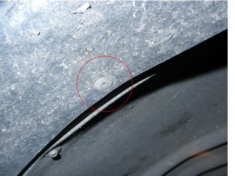 1990 Ford Bronco - Fender flare mounting point shown with a fastener highlighted by a red circle.