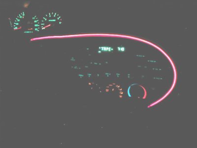 1997 Ford Taurus - Interior view of a car's dashboard, glowing pink accent lighting and a digital display showing 'TAPE 10'.