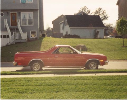 1979 Ford F-150 - A red 1979 Chevrolet El Camino is parked on the street in front of a suburban house.