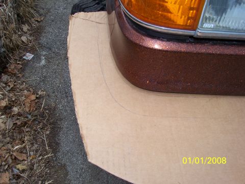 1989 Ford Bronco - A cardboard template is placed over the front corner of a brown metallic vehicle.