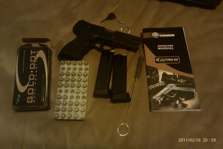 Pistol with two magazines, box of Gold Dot ammunition, and instruction manual