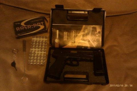 2000 Mercury Grand Marquis - A pistol is shown in its case with a box of Gold Dot ammunition, a cleaning rod, and the instruction manual.