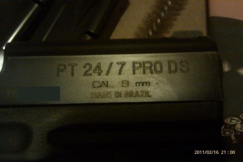 2000 Mercury Grand Marquis - Close-up of a Taurus PT 24/7 Pro DS pistol, marked 'Made in Brazil'.