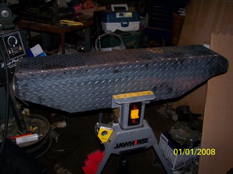 1989 Ford Bronco - Diamond plate toolbox resting on a JAWHorse sawhorse in a workshop setting.