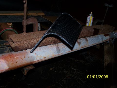 1989 Ford Bronco - Diamond plate metal being cut with a clamp and tool, with a spray can visible.