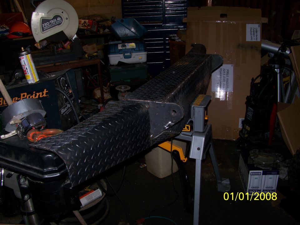 Diamond plate bumper on a stand in a workshop