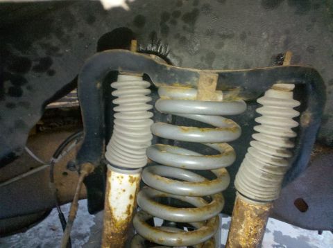 1995 Ford Bronco - Close-up view of the front suspension components, including coil springs and shock absorbers.