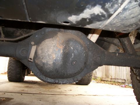1994 Ford Explorer - Underside view of a vehicle's rear differential, with visible oil buildup and suspension components.