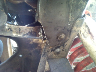 1985 Ford Bronco - This image shows a close-up view of the vehicle's frame and suspension system, a watermark from SuperMotors.net.