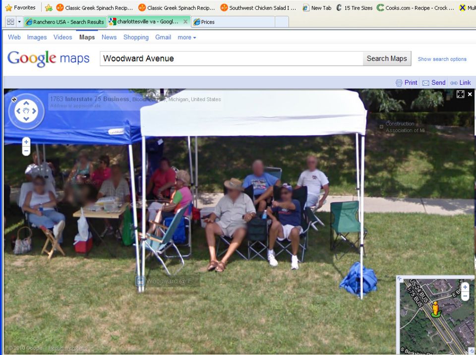 People gathered under tents on a grassy area