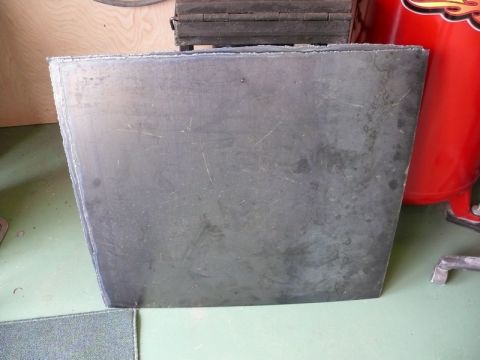 1976 Chevrolet Corvette - A gray metal panel is shown, possibly a car part, with visible scratches and a rough texture.
