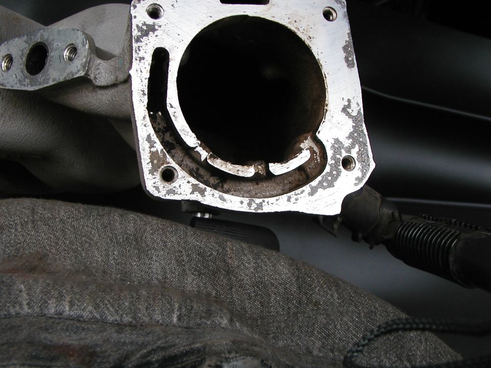 Intake manifold throttle body attachment point after I cleaned off all the carbon.