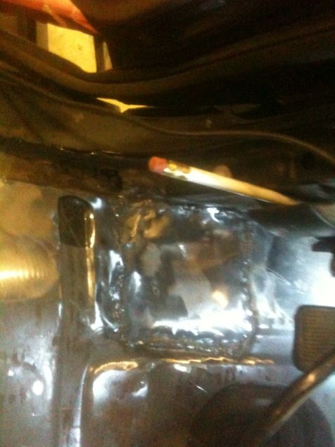 1993 Ford Bronco - A pencil rests on a freshly repaired section of a vehicle's floor pan.