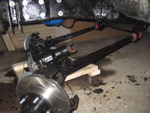 1979 Ford Bronco - Close-up view of vehicle suspension components, including brake rotors and control arms.