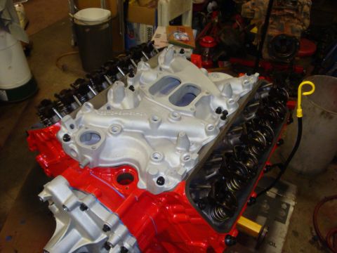 1989 Ford Bronco - A partially assembled engine sits on a stand, showing the block, intake, and valve train components.