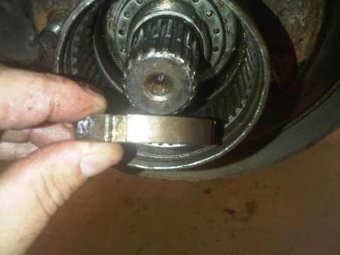 1978 Ford Bronco - A hand holds a part of a manual locking hub assembly, showing internal gears and bearings.