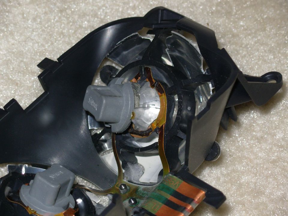 Reflector grille has melted, making bulb removal impossible.  Film traces (Copper) have begun to delaminate from plastic film.
IF THE IMAGE IS TOO SMALL, click it.