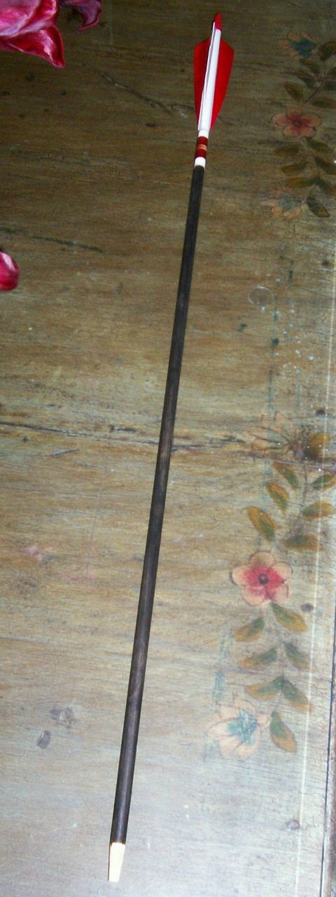 1993 Ford Bronco - An arrow with red and white fletching lies on a decorative surface.