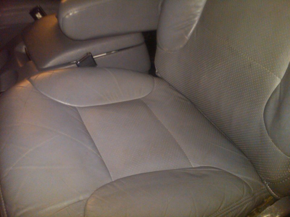 Close-up of gray leather car seats and center console
