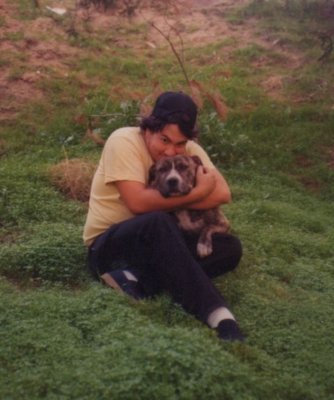 1968 Ford Mustang - A person embraces a dog in an outdoor grassy setting.