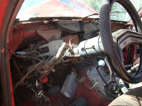 1986 Ford Bronco - Exposed wiring and damaged interior components are visible in this vehicle's cabin.