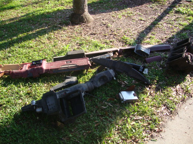 Disassembled dashboard components on grass
