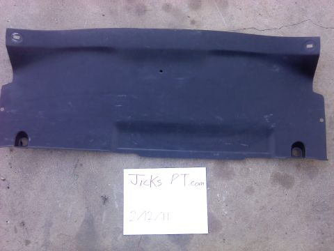 1995 Ford Probe - A dark plastic panel, likely an undertray, is shown against a concrete surface.