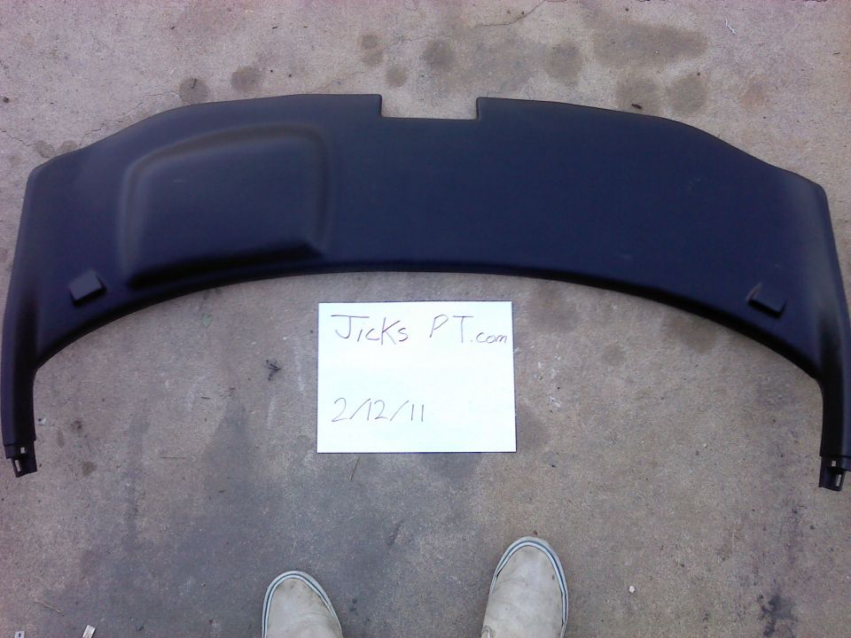 Black plastic automotive part with a handwritten note that says Jicks PT.com 2/12/11