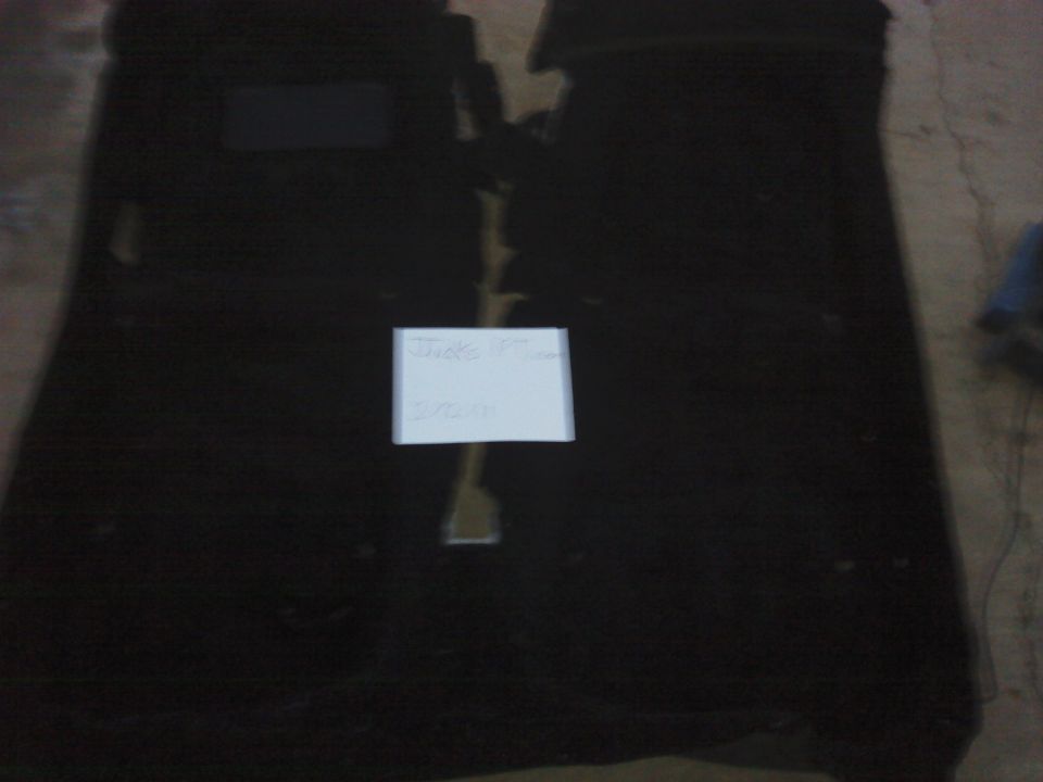 Black car floor mats with a white paper note on them