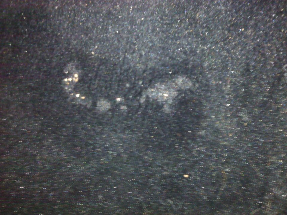 Dark textured surface with light spots