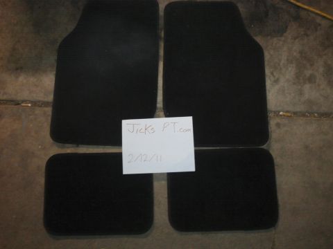 1995 Ford Probe - Set of four black car floor mats are shown on a concrete surface.