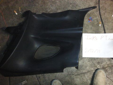 1995 Ford Probe - A black car door panel with a speaker grille is shown, with a handwritten note and cigarette butts nearby.