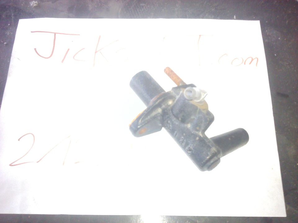 Automotive sensor part with handwritten text 'Jicks.com' and '21' on paper