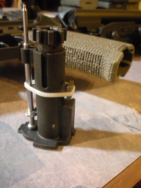 1996 Ford Bronco - A close-up view of a gun part, possibly a bolt carrier, secured with a zip tie.