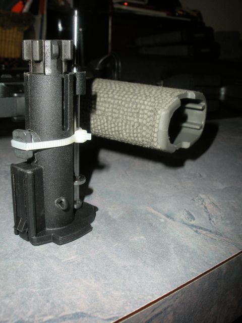 1996 Ford Bronco - A close-up view of a rifle's bolt carrier group, attached with a zip tie.